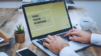A laptop with the words Find Your Purpose on the screen