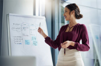 A woman in front of a whiteboard